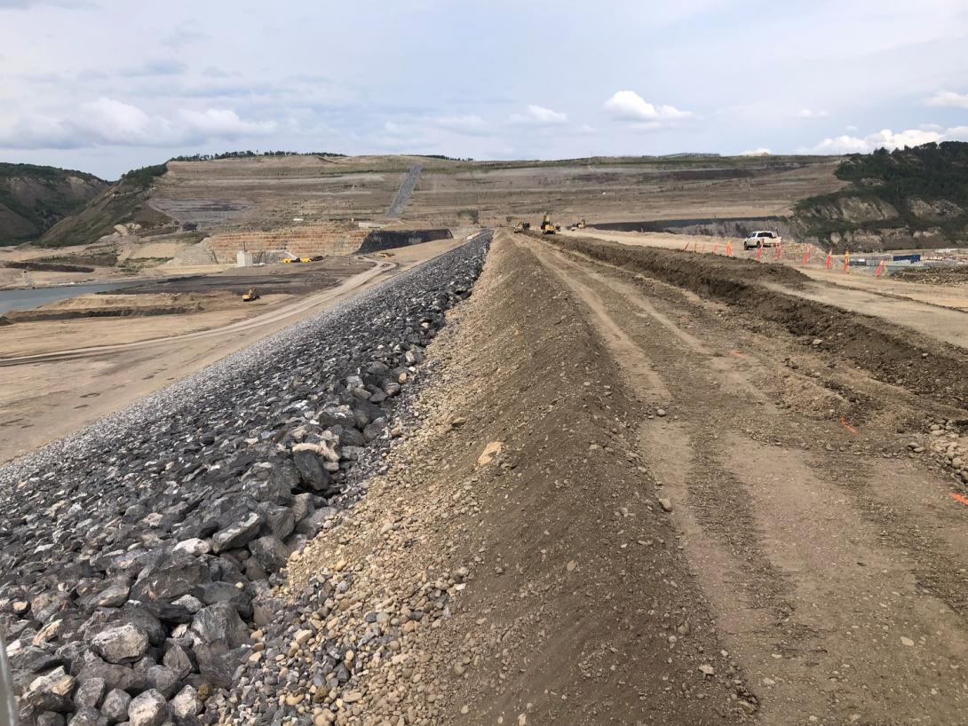 View across the completed earthfill dam, spanning one kilometre across the Peace River.