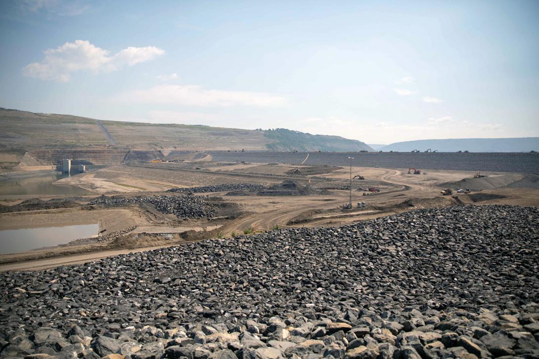 Crews finish the upstream shell of the dam. | June 2023