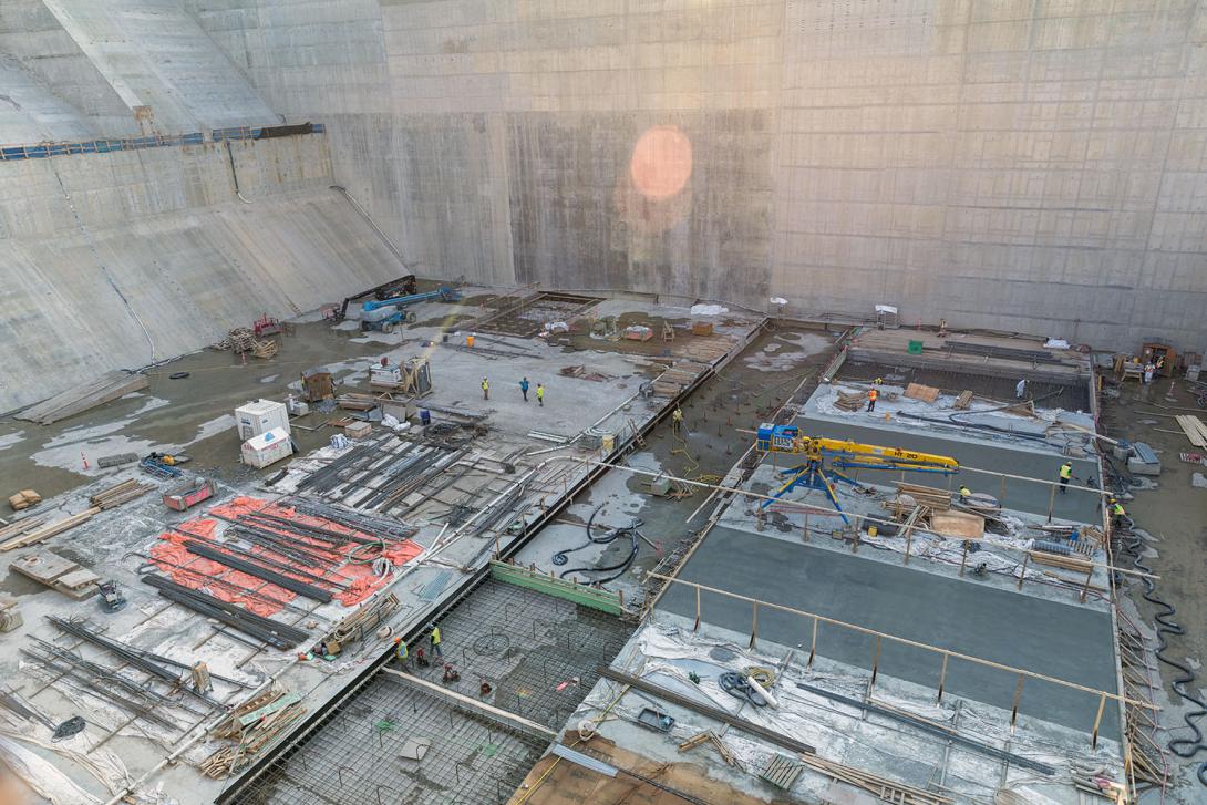 The west stilling basin has a patchwork of concrete placements to cover the bottom of the basin, since the area is too large for a single concrete placement. | July 2023
