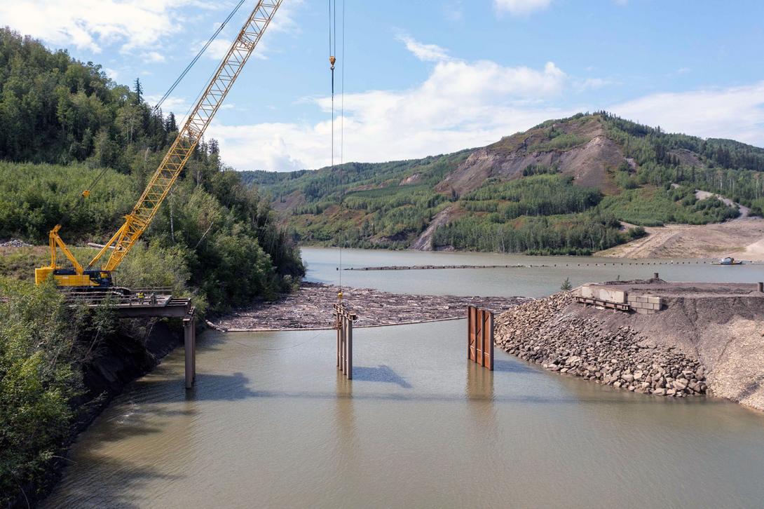 The temporary construction bridge over the Moberly River is being removed. | August 2023