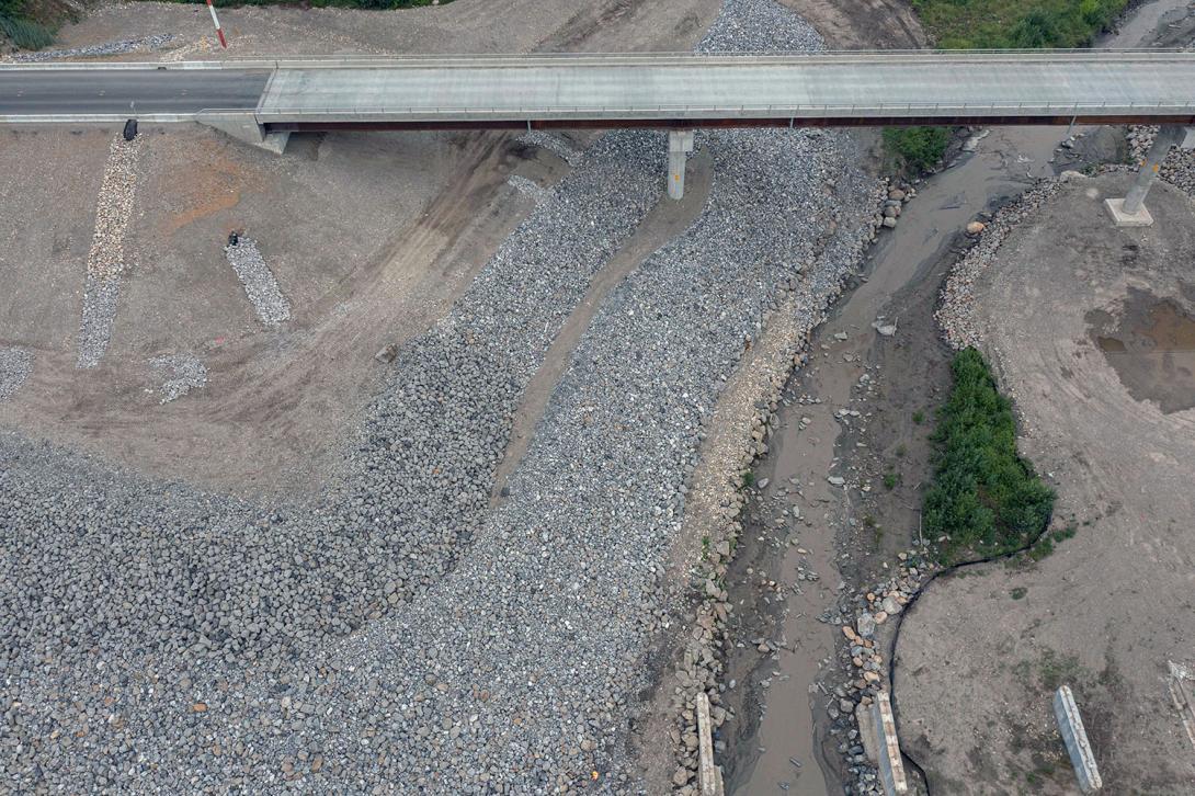 Wave-protection using riprap at the west abutment of the Lynx Creek Bridge realignment on Highway 29. | July 2023
