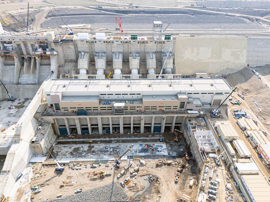 Water will exit the powerhouse through the tailrace outlets. Fish will be able to migrate upstream through the permanent facility on the right.