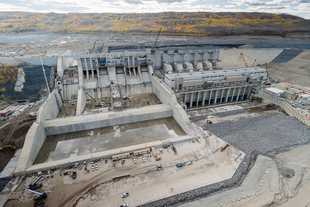 A downstream side view shows Site C’s spillways, penstocks, powerhouse, and tailrace.