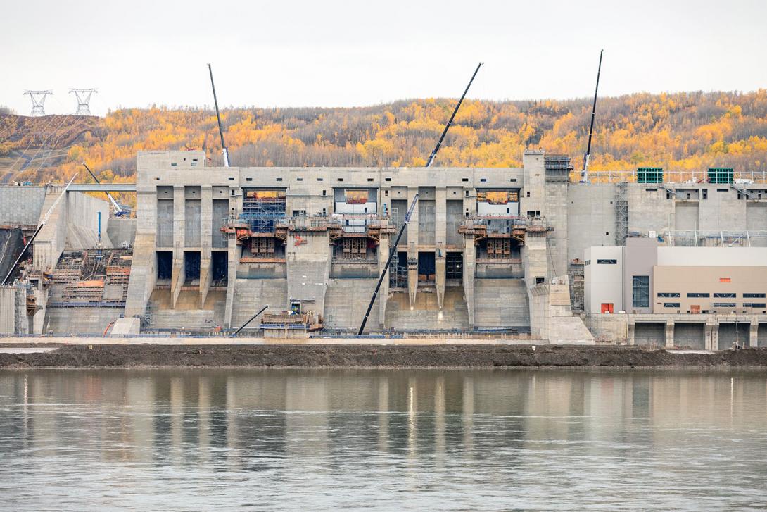 Site C has two mechanical spillways and an auxiliary spillway to safely pass flows from the reservoir. The right bank cofferdam in front will be removed when the dam is in operation.