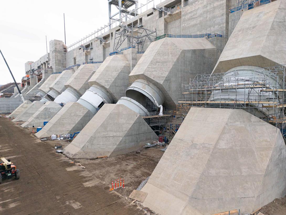 Concrete is completed on the six penstock units. Workers are installing flexible couplings, which join the lower and upper sections together to allow for movement between the two structures. | November 2023