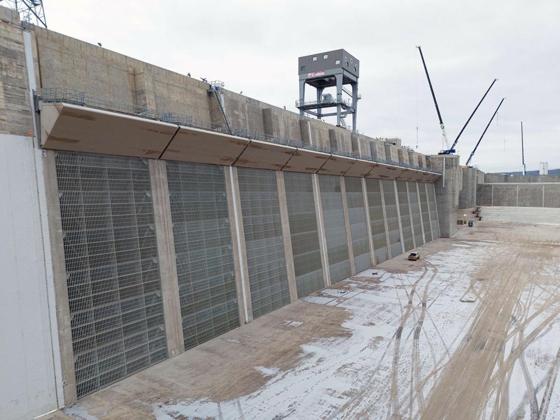 Trash racks are installed on each of the 12 intake openings. Trash racks collect large debris and prevent it from entering the turbine units. | November 2023