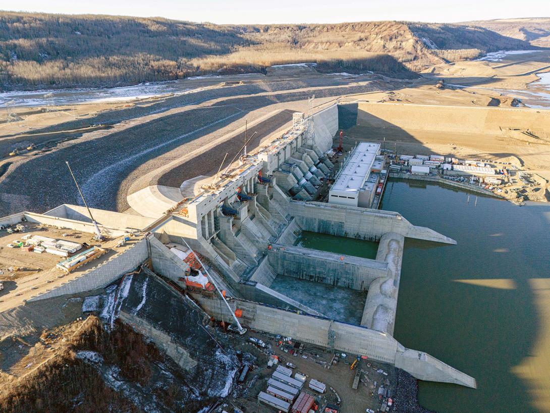 A downstream side view shows Site C’s spillways, penstocks, and powerhouse and operations building. | November 2023