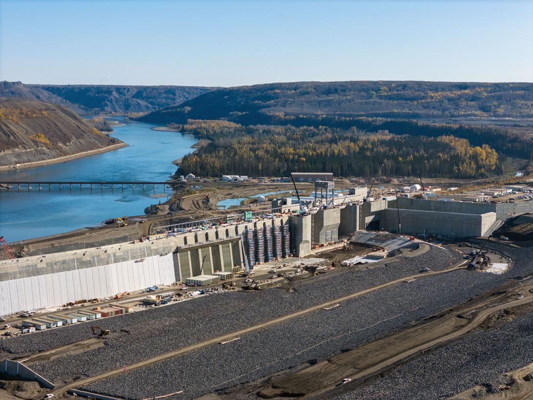 The approach channel carries water around the dam through the intakes at centre. The water travels through the intakes and down six penstocks to the turbine generating units.