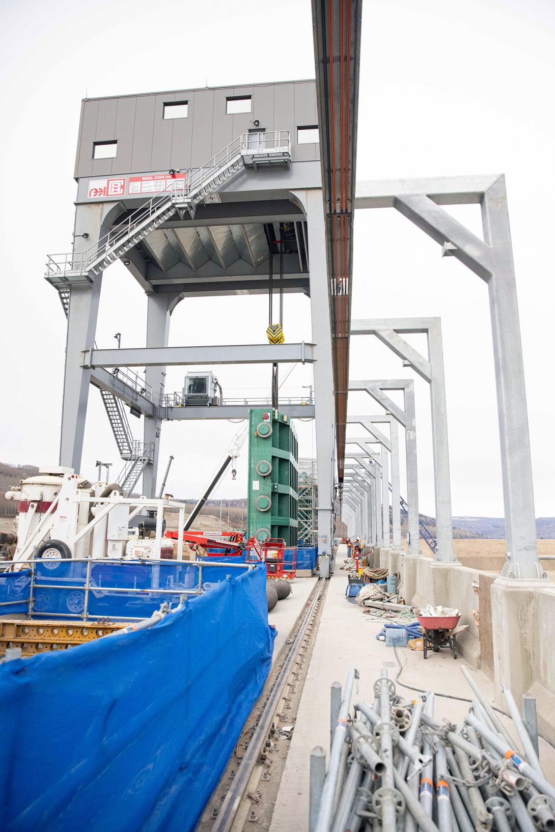 The gantry crane on the intake deck has a lifting capacity of 160 tonnes. It moves on rails and will lower and raise the intake gates, such as the green gate suspended from the crane.