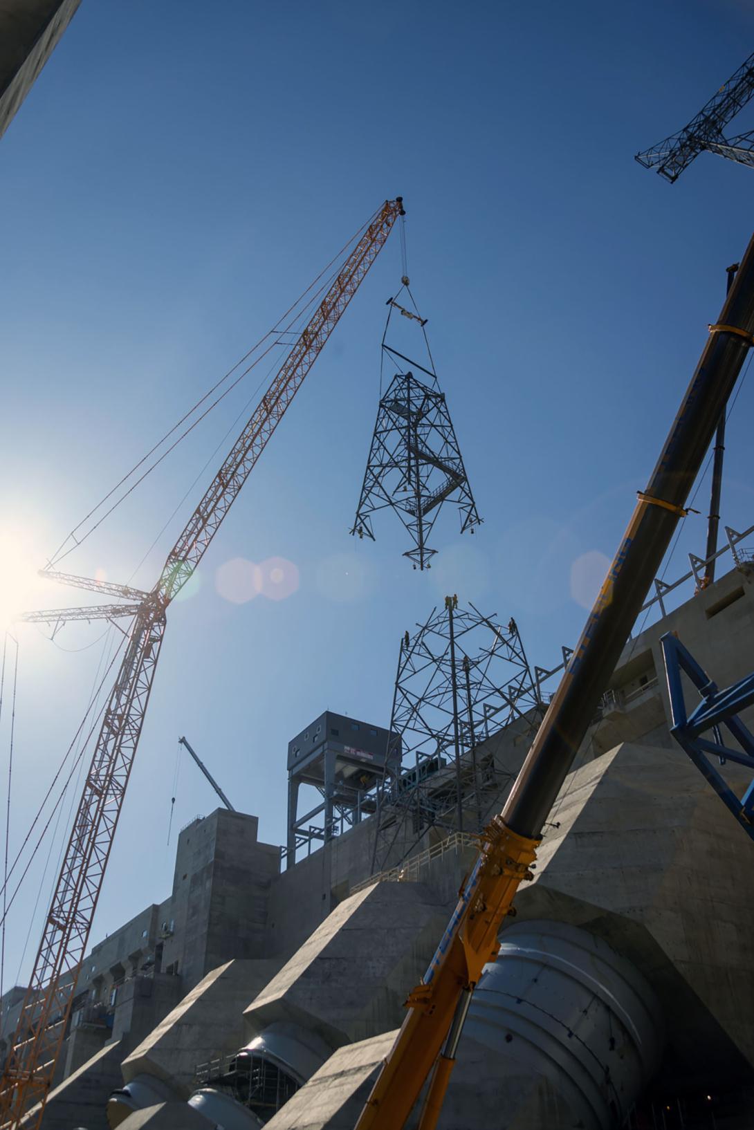 A 440-tonne crane lifts the second section of the transmission tower into position. 