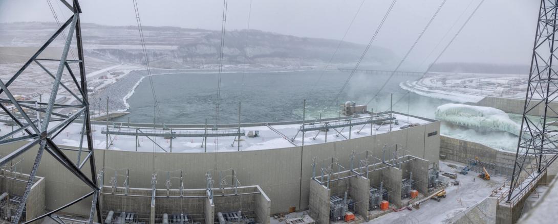 Facing the tailrace and north bank from the transformer yard behind the powerhouse. | March 2025