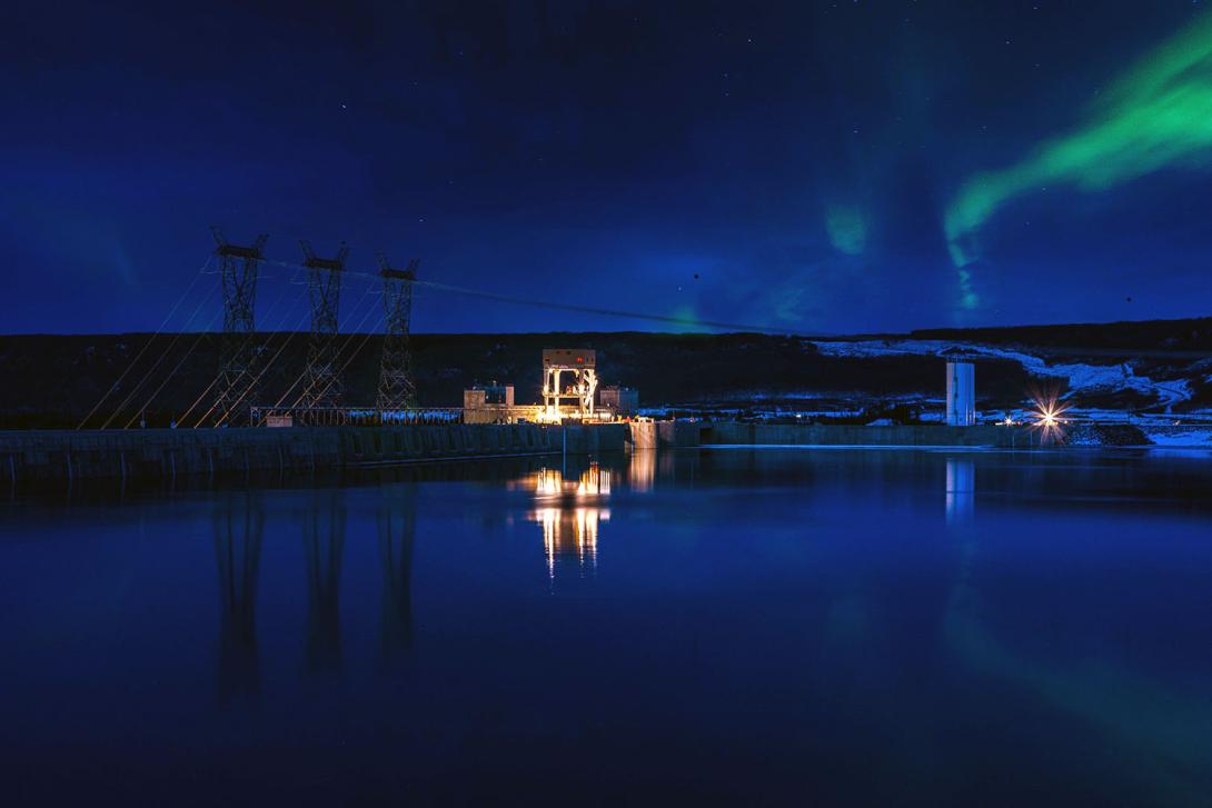 Permanent lighting on the dam and generating station under aurora borealis. | March 2025