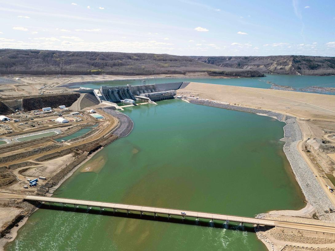 Aerial view upstream to the Site C dam, generating station, and reservoir. | April 2025