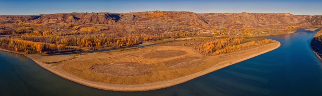Downstream of the Site C dam the shoreline of this island has been excavated to provide fish habitat. The submerged trenches in the riverbed (lower right) provide different water depths and water currents. | October 2025