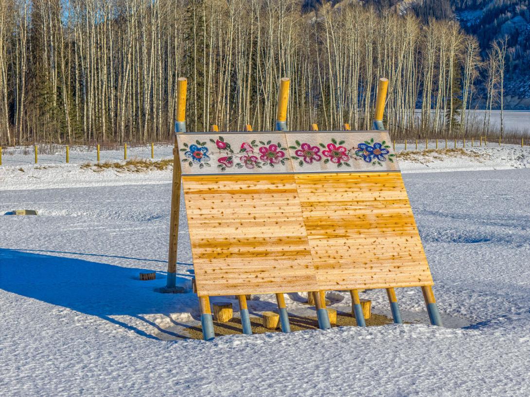 The lean-to installation at the Lynx Creek boat launch, with the display created by First Nation youth artists and the beadwork by artists from the Doig River First Nation. | January 2026
